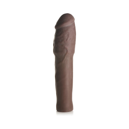 Dark brown extra thick penis extension sleeve with realistic texture and flexible design standing upright on white background.