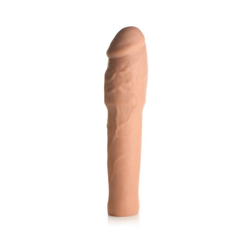 Medium-sized flesh-toned flexible penis extension sleeve with realistic texture and detailed veining.