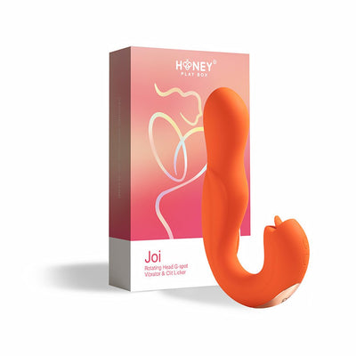 Orange ergonomic Joi rotating head G-spot vibrator and clit licker with packaging box on white background.