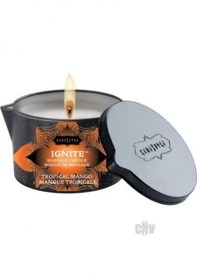 Kama Sutra Ignite Tropical Mango massage candle in black tin with lid, lit and ready for use.