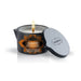 Kama Sutra Ignite Sweet Almond massage candle in a black tin with lid, lit and ready for use.