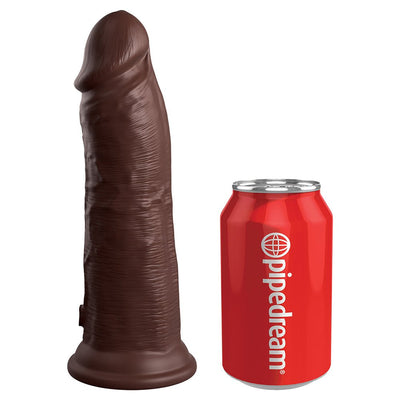 Dark brown realistic silicone dildo with suction base next to a red Pipedream soda can for size comparison.