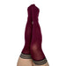 Pair of legs wearing Kixies Heather Cranberry opaque thigh-high stockings with black striped tops on white background.