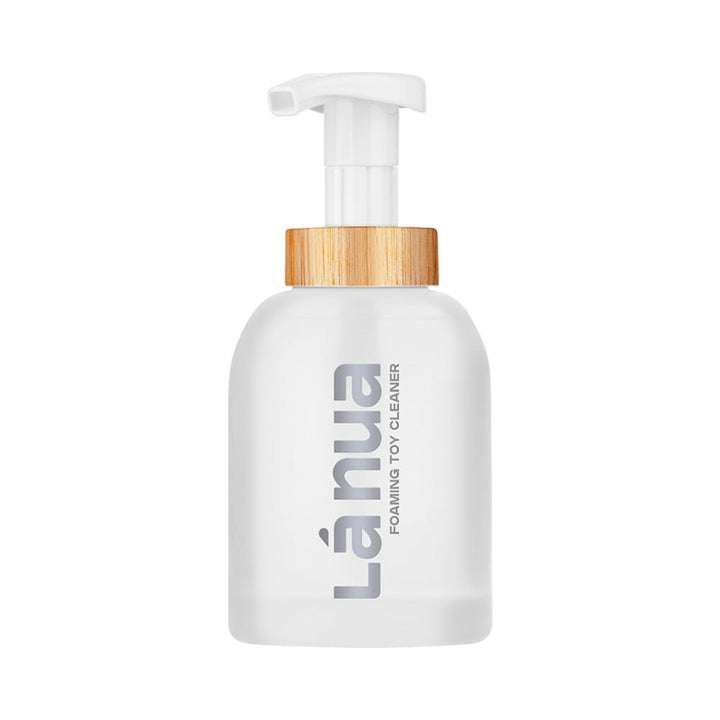 La Nua foaming toy cleaner bottle with white pump and wood-textured collar, minimalist design on white background.