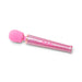 Pink glittery Le Wand Petite rechargeable massager wand with flexible head and three control buttons on white background.