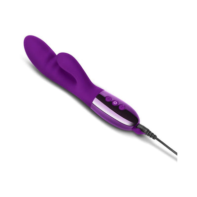 Purple dual-motor rabbit vibrator with ergonomic design and control buttons, shown charging with USB cable attached.