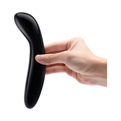 Hand holding a sleek black obsidian curved crystal wand designed for targeted G-spot stimulation.