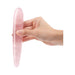 Hand holding a slim, smooth rose quartz crystal wand with a rounded tip against a white background.