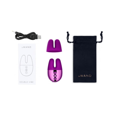 Le Wand Double Vibe with textured silicone sleeve, USB charging cable, instruction manual, and black travel pouch.