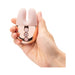 Hand holding a compact Le Wand Double Vibe with soft pink silicone bunny ears and rose gold control panel.
