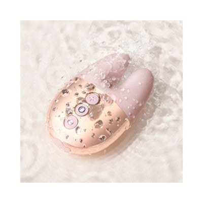 Le Wand Double Vibe in soft pink and rose gold with water droplets, shown in water to highlight waterproof feature.