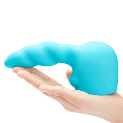 Hand holding a blue silicone textured attachment with a curved, twisty design for the Le Wand Unicorn Wand collection.