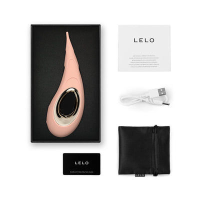 Lelo Dot Cruise vibrator in pink with gold accent, USB charging cable, black storage pouch, warranty card, and user manual in packaging.
