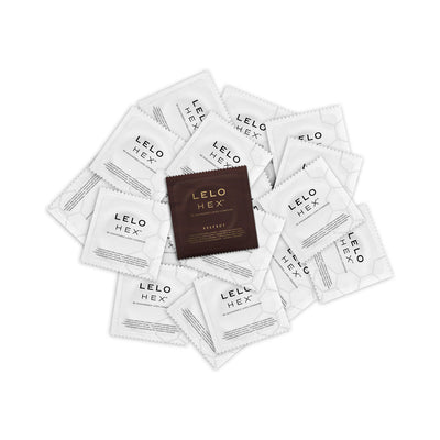 Lelo Hex Respect XL condoms in individual white and brown foil packets arranged in a scattered pile.