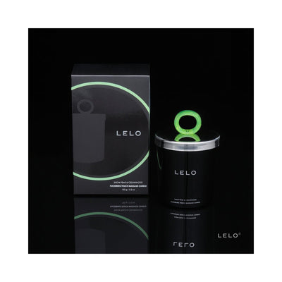 Lelo Massage Candle in black jar with green ring handle and matching black box with green accents on reflective black surface