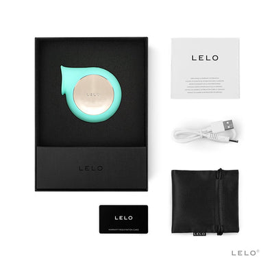 Lelo Sila Cruise sonic clitoral massager in aqua with USB charging cable, storage pouch, warranty card, and user manual in black box packaging.
