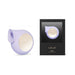 Lelo Sila Cruise sonic clitoral massager in lilac with gold accent next to its black packaging box.