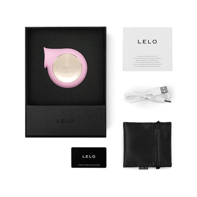 Lelo Sila Cruise pink clitoral massager with USB charging cable, satin pouch, warranty card, and user manual in black box packaging.