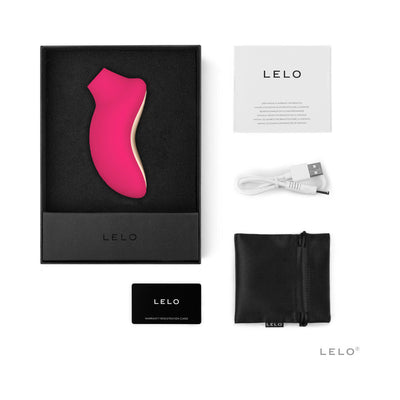 Lelo Sona 2 Cruise clitoral stimulator in pink with black storage pouch, USB charging cable, manual, and warranty card in packaging box.