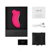 Lelo Sona Cruise clitoral stimulator in pink with USB charging cable, storage pouch, warranty card, and user manual in black box packaging.