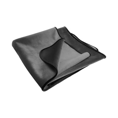 Folded dark gray waterproof plush throw blanket with black trim, designed for travel and easy cleanup.