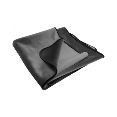 Folded black and gray waterproof plush travel throw with moisture barrier lining for easy cleanup.