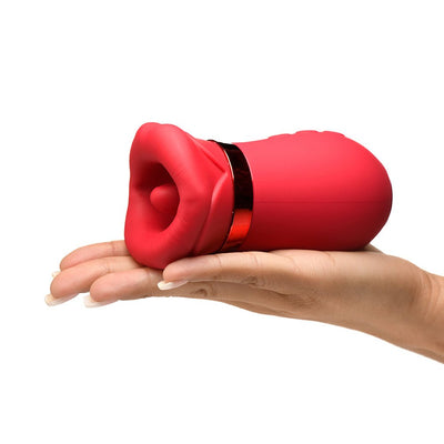 Hand holding a red silicone clitoral stimulator shaped like soft, kissing lips with a shiny band detail.