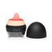 Compact clitoral stimulator with soft pink tongue and red lips design, black base, and removable black cap.