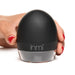 Hand holding black dome-shaped inmi personal care device with clear base on white background