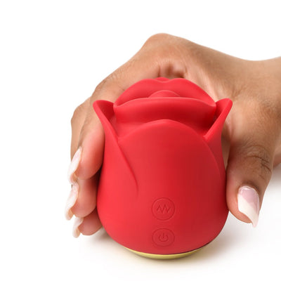 Hand holding a red silicone rose-shaped clitoral stimulator with control buttons on a white background.