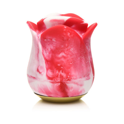 Compact rose-shaped clitoral stimulator in red and white silicone with a gold base, designed for gentle vibrating pleasure.