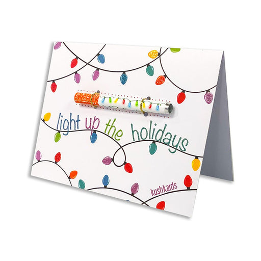 Holiday greeting card with colorful string lights design and a festive one hitter pipe attached, reading light up the holidays.