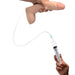 Hand holding a realistic dual-density 10-inch dildo connected to a syringe with tubing for fluid release.