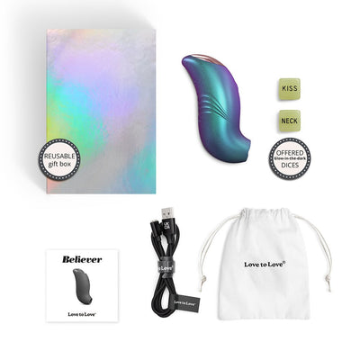 Iridescent Love To Love Believer device with reusable gift box, glow-in-the-dark dice, charging cable, pouch, and user manual.