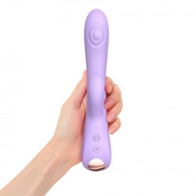 Hand holding a lavender dual stimulator with ergonomic design and control buttons on the handle.
