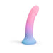 Curved silicone dildo with suction base in gradient pink, purple, and blue, glow-in-the-dark finish.