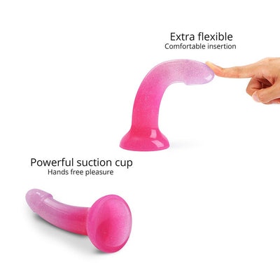 Pink and purple gradient silicone dildo with multicolor star glitter, flexible curved design and suction cup base for hands-free use.