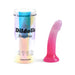 Pink to purple gradient silicone dildo with star glitter and suction base next to iridescent cylindrical packaging.