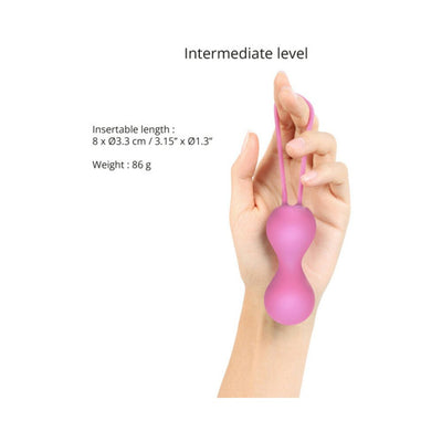 Hand holding pink silicone Kegel balls with dimensions and weight details for intermediate level use.