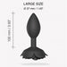 Large black silicone anal plug with decorative open rose base, measuring 100mm length and 37mm diameter.