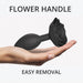 Black silicone anal plug with a rose-shaped handle held in an open palm for easy removal.