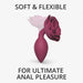 Medium plum-colored anal plug with a rose-shaped base, soft and flexible for comfortable use.