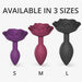Three rose-shaped anal plugs in small purple, medium pink, and large black sizes displayed on a white background.