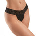 Close-up of a woman wearing black lace G-string panties with a wide floral lace waistband.