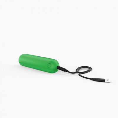 Compact green bullet vibrator with USB charging cable on white background