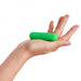 Hand holding a small, green, compact bullet vibrator with a smooth, rounded design.