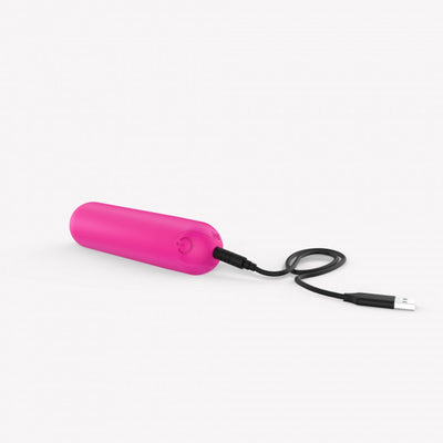 Pink compact bullet vibrator with USB charging cable on white background.