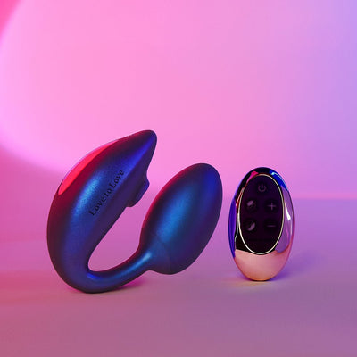 Love To Love Wonderlover flexible silicone stimulator with remote control in blue and rose gold on pink-purple background.