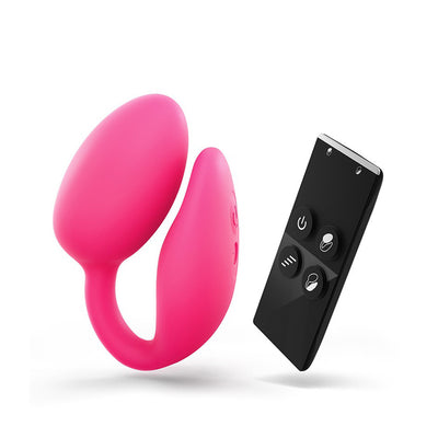 Pink dual stimulator with curved design and black wireless remote control with four buttons on white background.