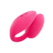 Pink dual stimulator with smooth silicone texture and control buttons on top, designed for versatile use.